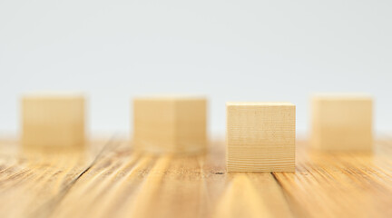 empty wooden cubes for own messages and icons on wooden floor and white background