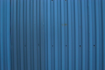 A metal grey fence, a natural abstract background gray light blue color
