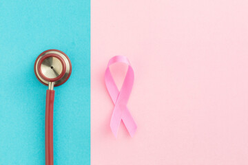 Breast Cancer concept : Top view pink ribbon and red stethoscope symbol of breast cancer campaign...