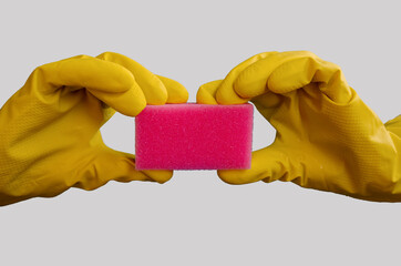 hand in a yellow glove holds a pink sponge on a white background. Cleaning time. Purity.