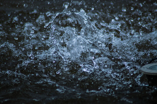 Beautiful bright splashes in the water. Water splashes from the fountain. Drops hitting the water © Zueva Alyona
