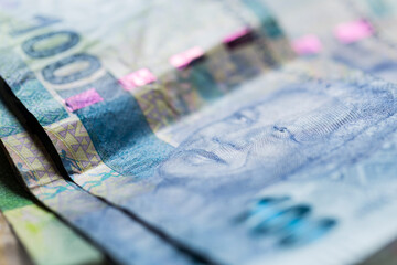 Obverse of South African ZAR banknote with a denomination of 100 rand and an image of Nelson Mandela.