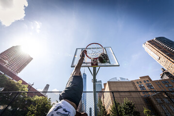 Basketball player making huge slam dunk