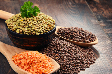 Composition with bowl of lentils on wooden table