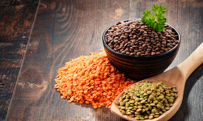 Composition with bowl of lentils on wooden table
