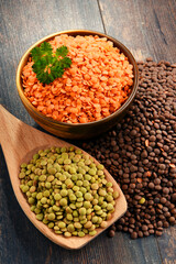 Composition with bowl of lentils on wooden table