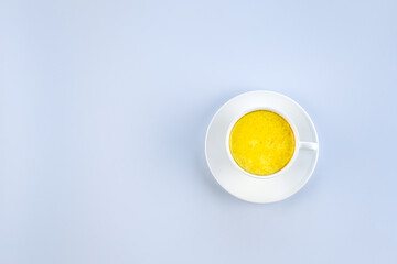 Golden milk and on a blue background with copy space. Masala Haldi Doodh. Alternative medicine concept