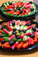two plates with sliced fresh vegetables and one of them in focus