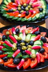 two plates with sliced fresh vegetables and one of them in focus