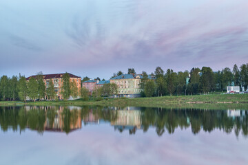 Fototapeta premium reflection of houses in a pond at sunset