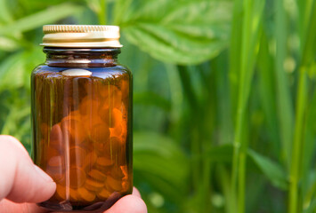 Supplements glass bottle against soft-focus backdrop