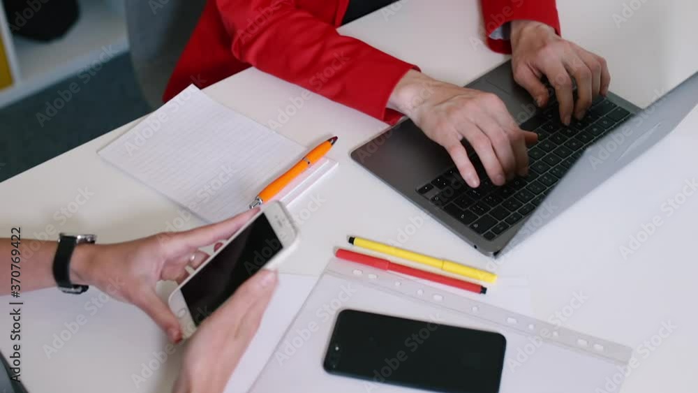 Poster work desk of an office worker with a client. a woman uses a laptop to fill in informative data in a 