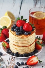 A stack if home-made pancakes with berry	