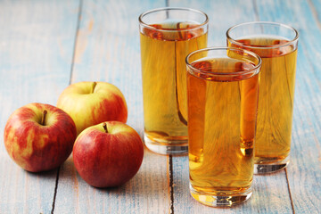 Glasses with apple juice and ripe apples	