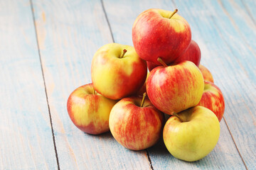 Several ripe red apples on the wooden table