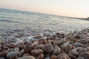 Fototapeta na wymiar Waves washing over pebble beach