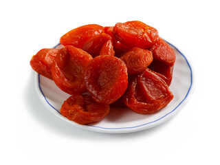 bright red dried apricots on a white saucer with a blue border, isolated on a white background