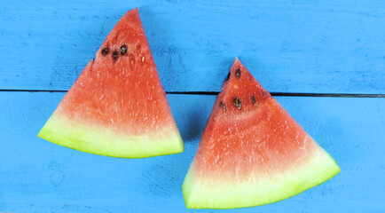    Watermelon slices on blue wooden background. Fruits, freshness, summer concept          