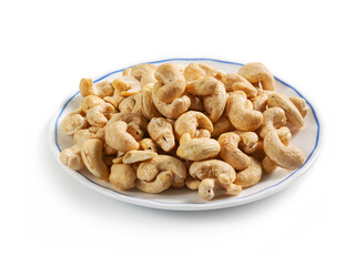 cashew peeled nuts on a white saucer with a blue border, isolated on a white background