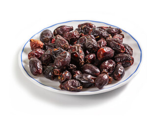 dried rosehip on a white saucer with a blue border, isolated on a white background
