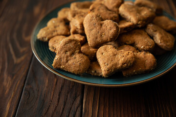 Close-up homemade wholegrain cookies with oatmeal, raisin, nuts, seeds and milk on brown rustic wooden background. Healthy eating concept.  Copy space.