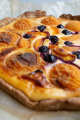 baking pie with apricots and blueberries close up