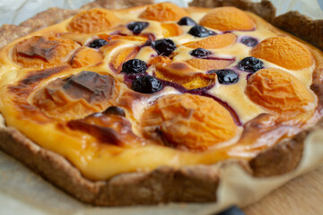 baking pie with apricots and blueberries close up