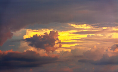 The clouds are beautifully illuminated by the setting sun.