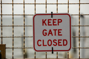 keep gate closed sign red letters 