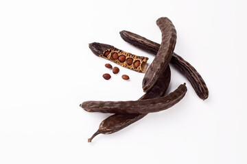 Dried carob on the white background