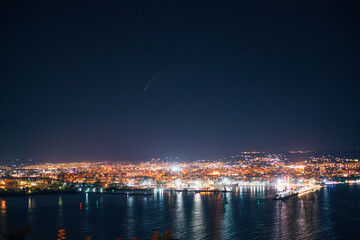 Obraz na płótnie Canvas Night view toward Varna, Bulgaria. Seascape with reflection of city lights in the sea water.