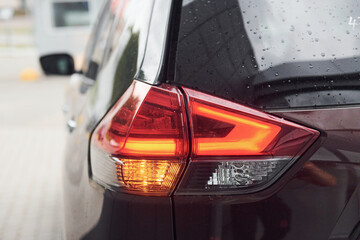 Rear particle view of modern black automobile. Close up view of headlights