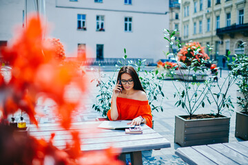 Pensive attractive student dressed in casual outfit having mobile conversation via cellphone...