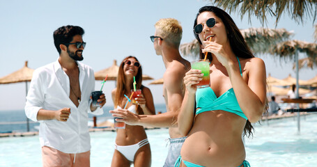 Group of happy friends having fun on tropical beach, summer holiday party
