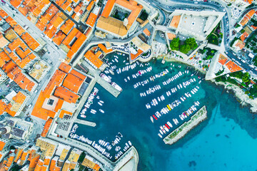 Aerial view down to the port of DUBROVNIK with many ships standing in a sunny day. Cruise and travel in Croatia.