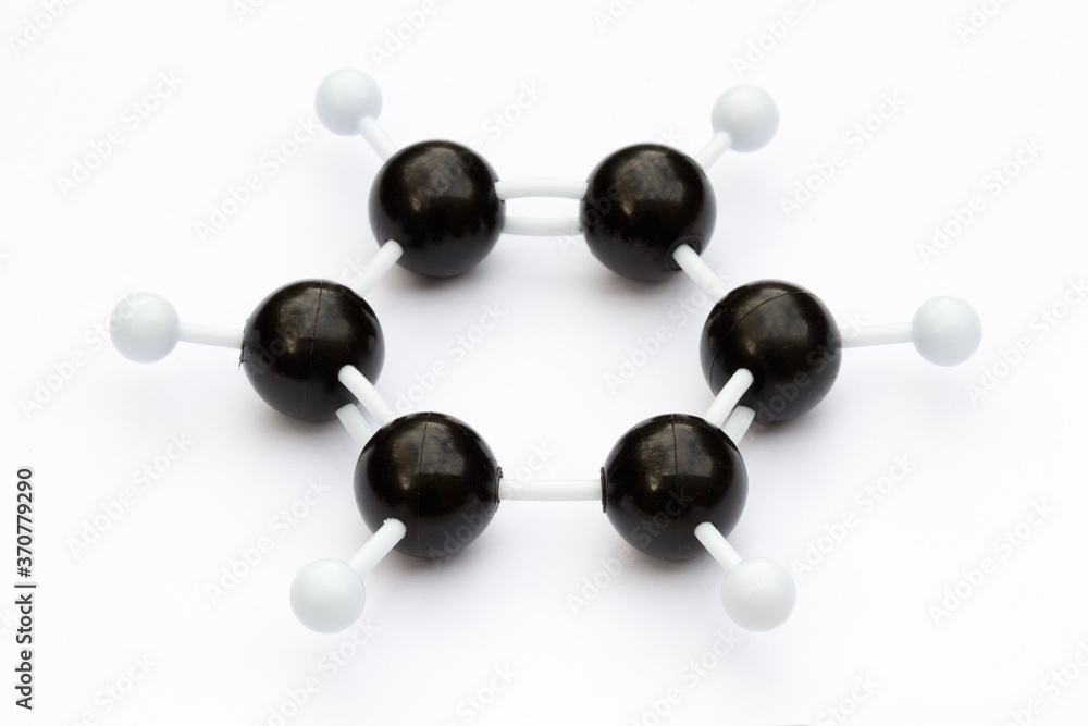 Wall mural Plastic ball-and-stick model of a benzene molecule (C6H6) on a white background. The molecule is shown with kekule structure. Shallow depth of field.