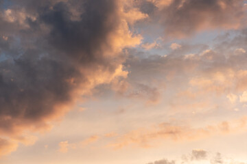 Clouds on the sunset sky background.