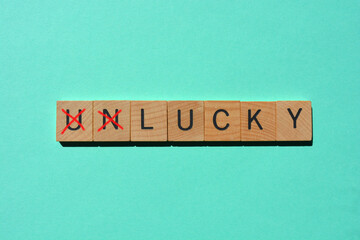Unlucky, word with prefix Un crossed out, leaving the positive wiod Lucky