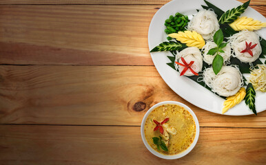 Top view Thai noodle with curry in white dishes on wooden table