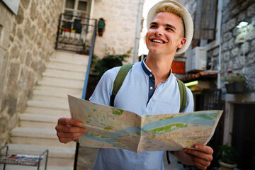 Happy young man smiling and traveling at summer vacation