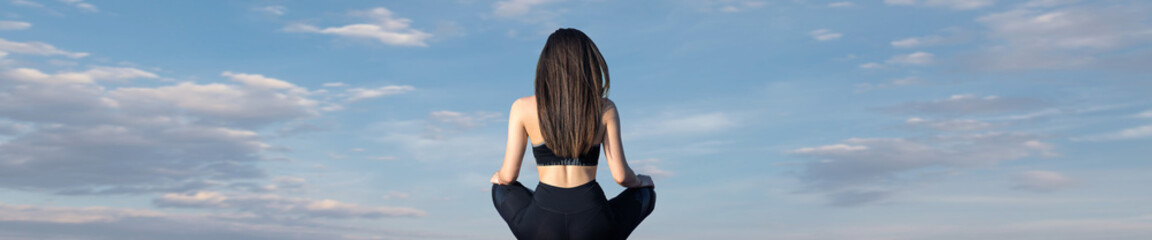 A young slim athletic girl in sportswear performs a set of exercises. Fitness and healthy lifestyle.