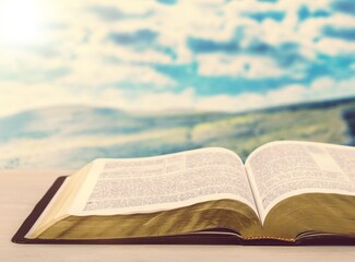 Holy Bible book on a wooden desk