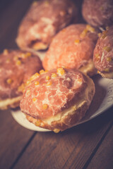 Traditional Polish donuts on wooden background. Tasty doughnuts with jam