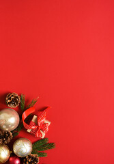 Beautiful Christmas decoration with gifts and balls on a red background. View from above. New Year's layout.