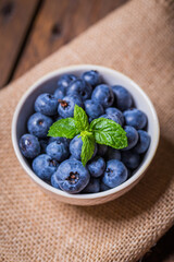 Blackberries in white bowl on wooden table