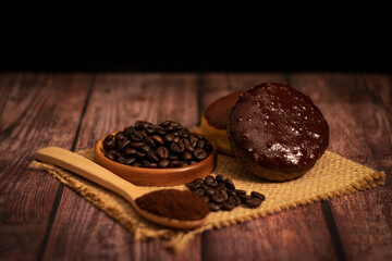 Coffee Donut with organic coffee beans on the wooden table and the black background