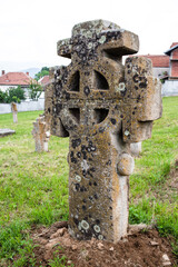 Old, granite tombstone in the church backyard