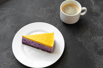 Piece of blueberry cheesecake with yellow topping
