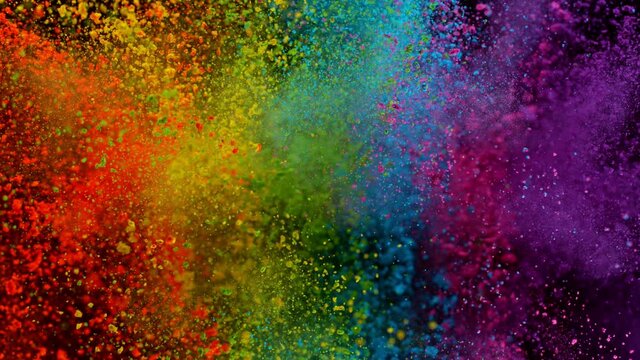 Colorful powder exploding on black background in super slow motion, close-up.