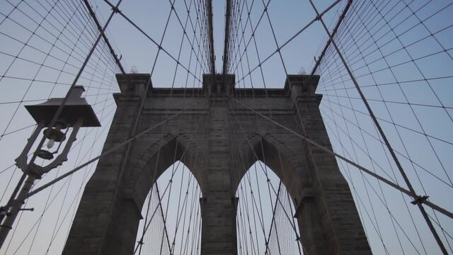 Empty Brooklyn Bridge with no people early morning at sunrise in beautiful sunlight in summer 